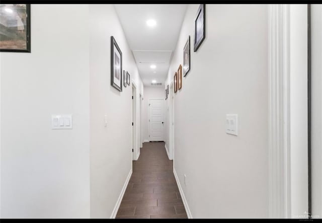 hallway featuring wood finish floors, baseboards, attic access, and recessed lighting