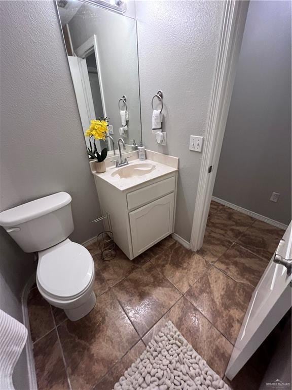 3404 Robin Ave, Pharr, TX 78577 - bathroom with vanity, toilet, and tile patterned flooring
