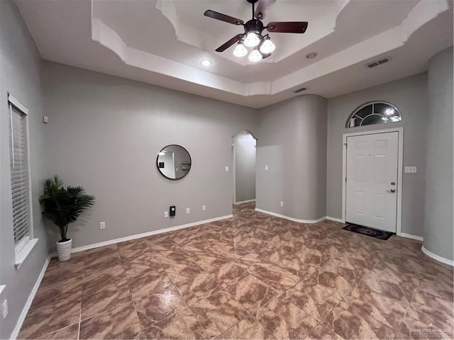3404 Robin Ave, Pharr, TX 78577 - empty room with a raised ceiling, arched walkways, ceiling fan, and baseboards