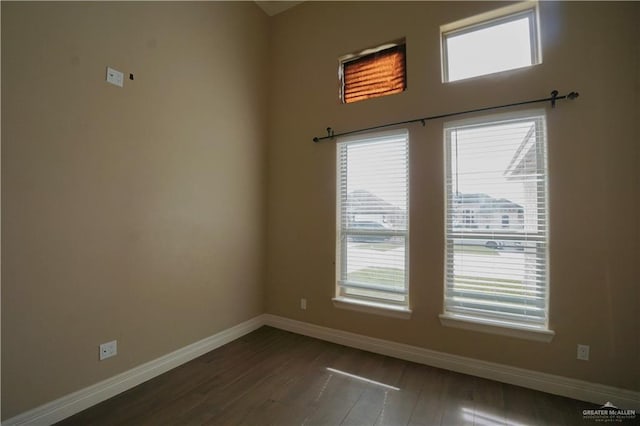 unfurnished room featuring dark wood-type flooring