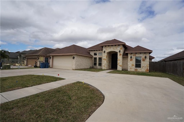 mediterranean / spanish-style house with a garage and a front yard