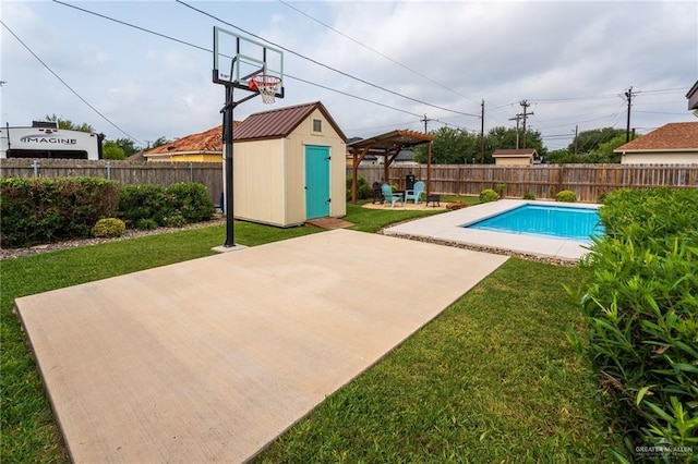 view of pool featuring a lawn, an outdoor structure, a fenced backyard, and a storage unit