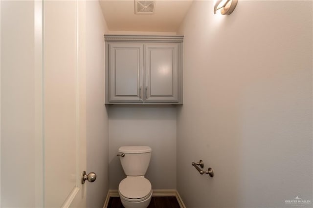 bathroom with visible vents, baseboards, and toilet