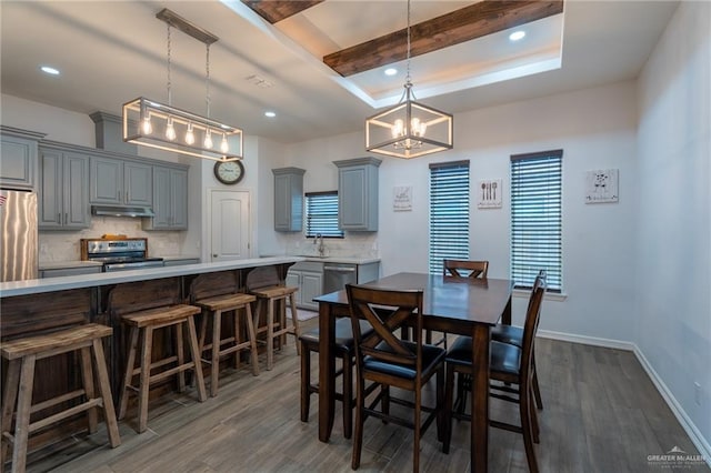 dining space with an inviting chandelier, recessed lighting, baseboards, and dark wood finished floors