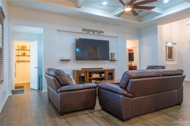 living area with a ceiling fan, beamed ceiling, wood finished floors, and coffered ceiling