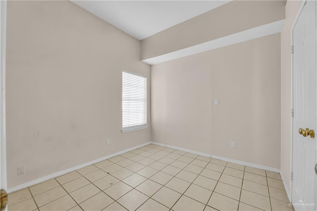 unfurnished room featuring baseboards