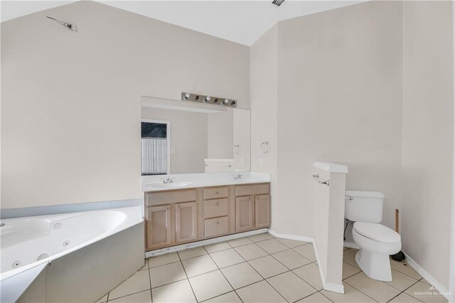 full bath featuring double vanity, toilet, tile patterned floors, a whirlpool tub, and a sink