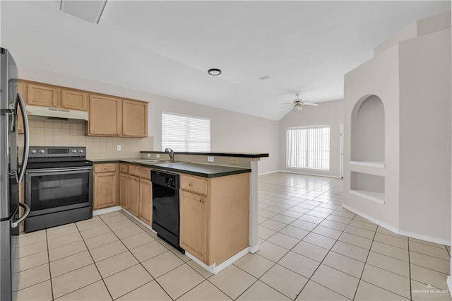 kitchen featuring light tile patterned flooring, a sink, a peninsula, under cabinet range hood, and black appliances