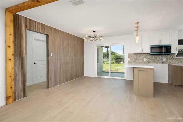 2901 Upas Ave, Mcallen, TX 78501 - kitchen featuring stainless steel microwave, a notable chandelier, visible vents, and light wood-type flooring