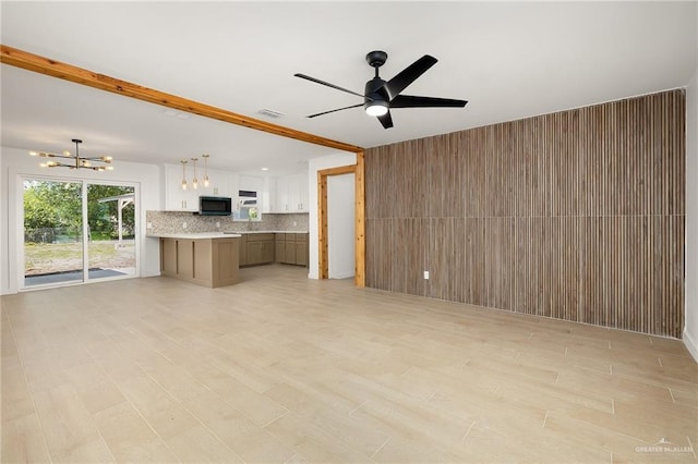 2901 Upas Ave, Mcallen, TX 78501 - unfurnished living room featuring ceiling fan with notable chandelier, light wood finished floors, and visible vents