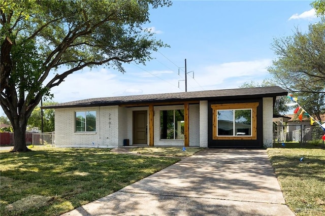 2901 Upas Ave, Mcallen, TX 78501 - view of front of home featuring concrete driveway, fence, a front lawn, and brick siding