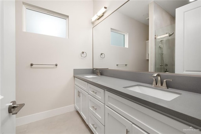 bathroom featuring a healthy amount of sunlight, a shower with door, and vanity