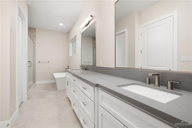 bathroom featuring vanity and independent shower and bath