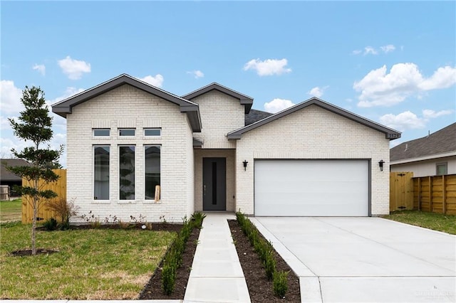 view of front of home featuring a garage and a front yard