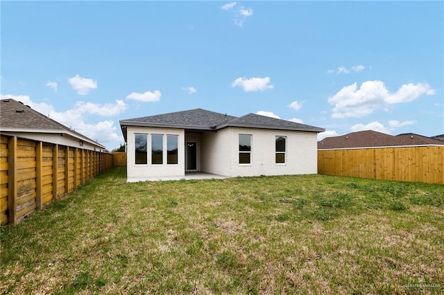 rear view of house featuring a yard and a patio area