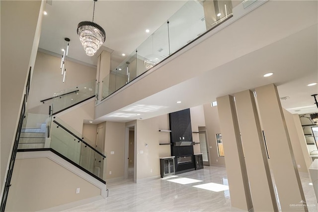 3905 Tierra Escondida, Weslaco, TX 78596 - interior space with baseboards, a high ceiling, a notable chandelier, recessed lighting, and stairs