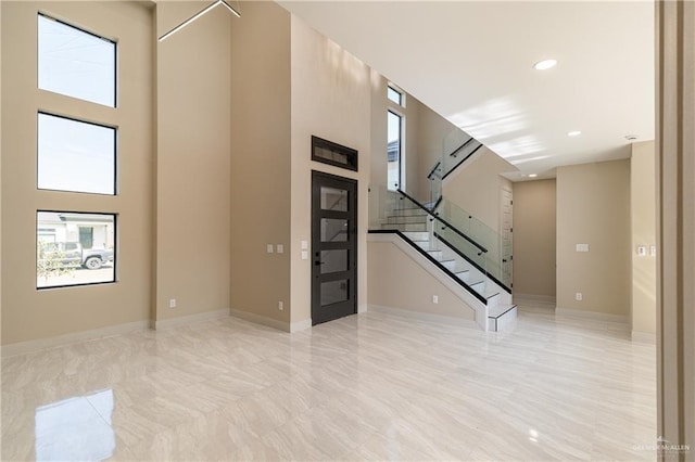 3905 Tierra Escondida, Weslaco, TX 78596 - interior space featuring recessed lighting, a towering ceiling, baseboards, and stairs