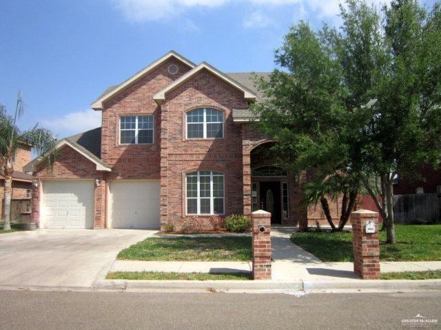 2603 Norma Dr, Mission, TX 78574 - traditional-style house with brick siding, driveway, and a front lawn
