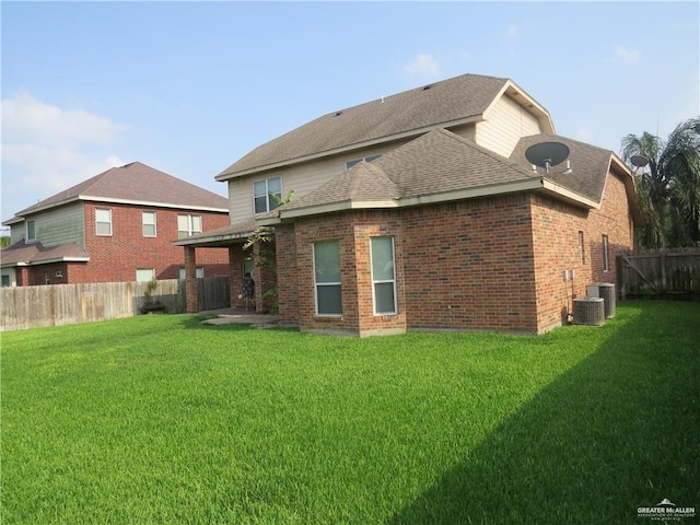 2603 Norma Dr, Mission, TX 78574 - rear view of property with a fenced backyard, roof with shingles, and brick siding