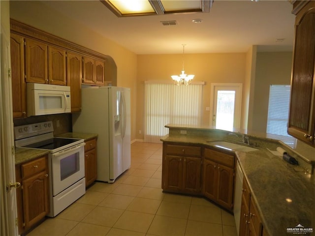 2603 Norma Dr, Mission, TX 78574 - kitchen with white appliances, light tile patterned flooring, a chandelier, decorative light fixtures, and brown cabinetry