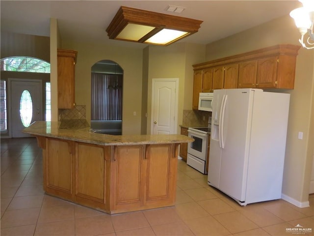 2603 Norma Dr, Mission, TX 78574 - kitchen with white appliances, a peninsula, tasteful backsplash, and a kitchen breakfast bar