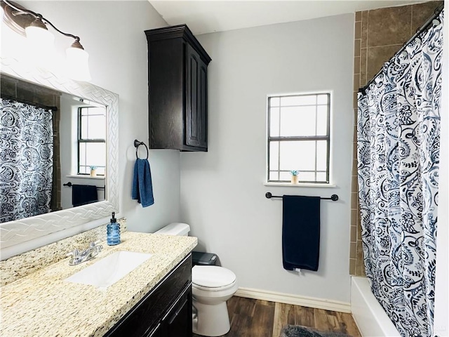 bathroom with vanity, wood finished floors, toilet, and baseboards