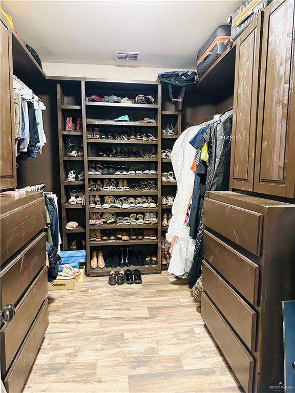 spacious closet with visible vents and light wood-style flooring