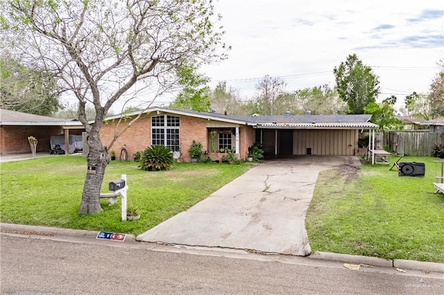 ranch-style home featuring a carport and a front lawn