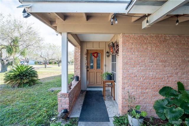 property entrance with a lawn