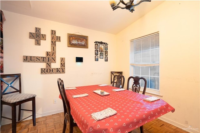 dining room featuring lofted ceiling and parquet floors