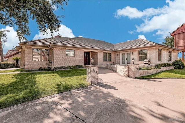 view of front of house with french doors and a front lawn