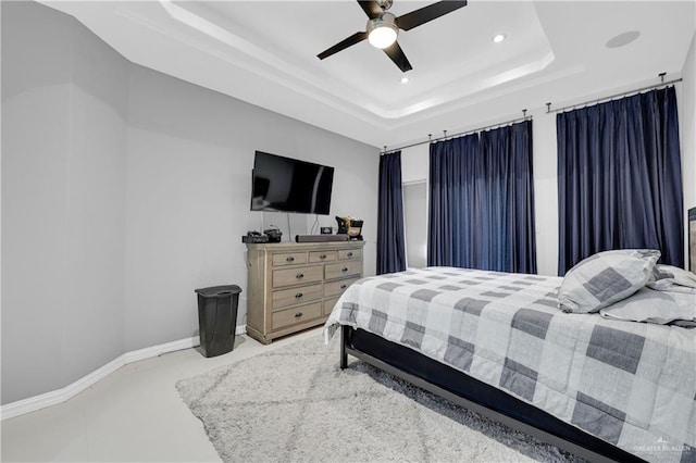 bedroom featuring recessed lighting, a raised ceiling, a ceiling fan, and baseboards