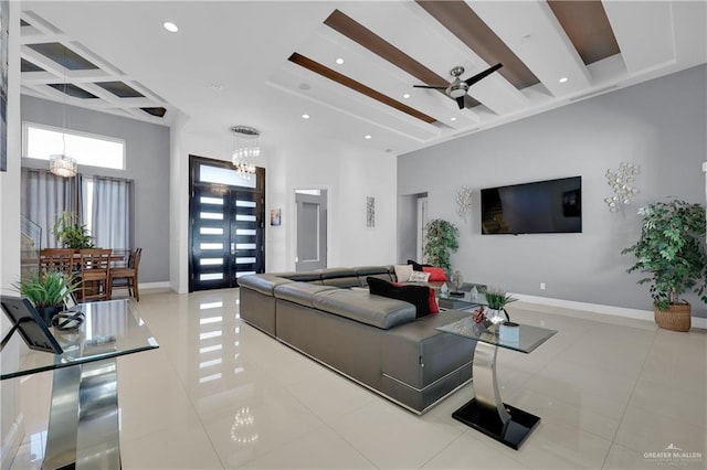 living room featuring beamed ceiling, coffered ceiling, tile patterned floors, and baseboards