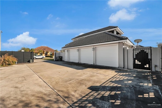 garage with fence and a gate