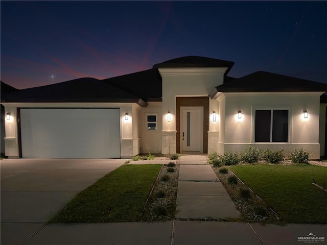 view of front of home featuring a garage and a front lawn