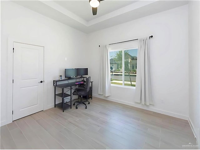 office with ceiling fan and light hardwood / wood-style flooring