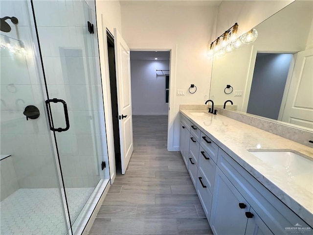 bathroom featuring vanity and a shower with shower door