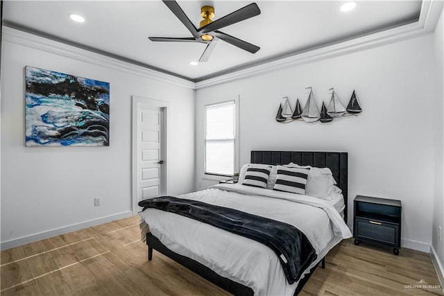 bedroom with wood-type flooring, ceiling fan, and crown molding