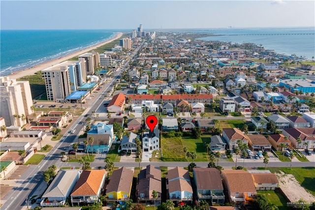 drone / aerial view featuring a water view and a beach view