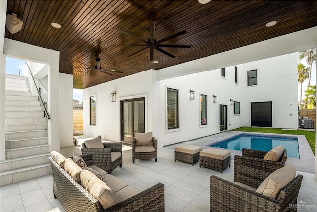 exterior space featuring french doors, an outdoor living space, ceiling fan, central AC, and a patio