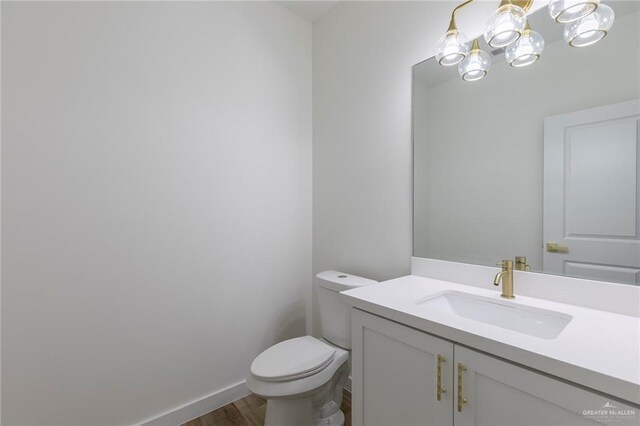 5706 N 44th Ln, Mcallen, TX 78504 - bathroom featuring wood finished floors, vanity, and a chandelier