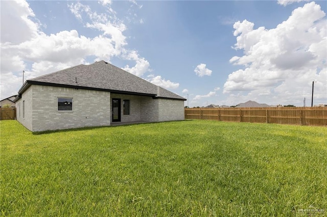 5706 N 44th Ln, Mcallen, TX 78504 - rear view of house with a shingled roof and brick siding