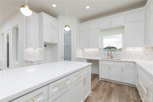 5706 N 44th Ln, Mcallen, TX 78504 - kitchen with white cabinetry, decorative light fixtures, light wood-style floors, and recessed lighting