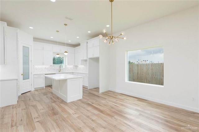 5706 N 44th Ln, Mcallen, TX 78504 - kitchen with tasteful backsplash, a chandelier, a kitchen island, white cabinets, and recessed lighting