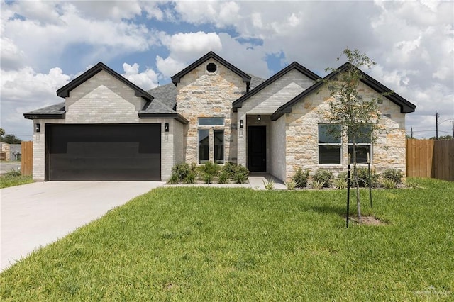 5706 N 44th Ln, Mcallen, TX 78504 - view of front of house with an attached garage, stone siding, and concrete driveway