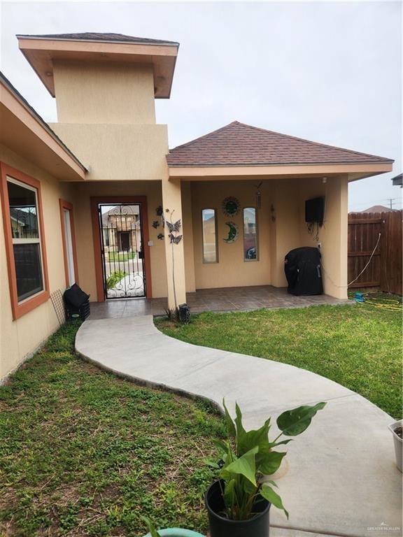 entrance to property with a yard