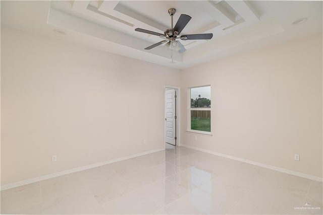 3216 E Alexa St, Edinburg, TX 78542 - spare room featuring a raised ceiling, light marble finish flooring, a ceiling fan, and baseboards