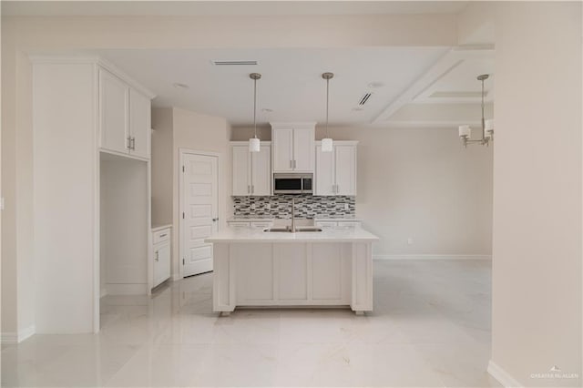 3216 E Alexa St, Edinburg, TX 78542 - kitchen with a sink, stainless steel microwave, light countertops, decorative backsplash, and white cabinetry