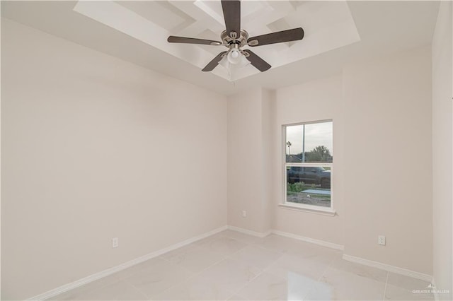 3216 E Alexa St, Edinburg, TX 78542 - empty room with light marble finish floors, a ceiling fan, a raised ceiling, and baseboards