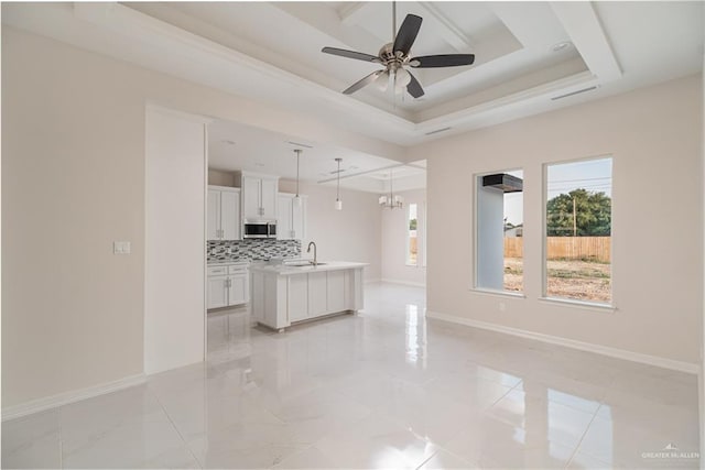 3216 E Alexa St, Edinburg, TX 78542 - living area featuring healthy amount of natural light, a tray ceiling, a ceiling fan, and baseboards